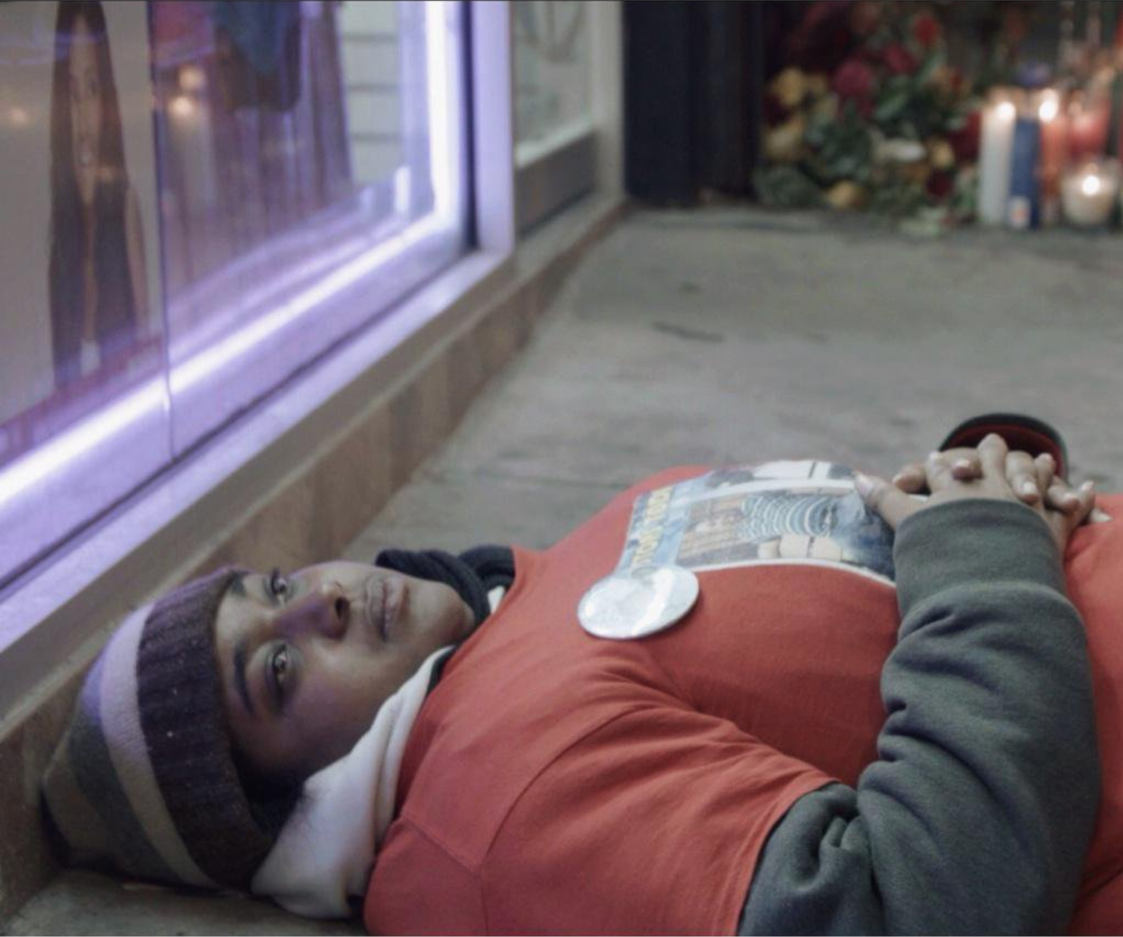 Erica Garner lying in the place where her father was killed